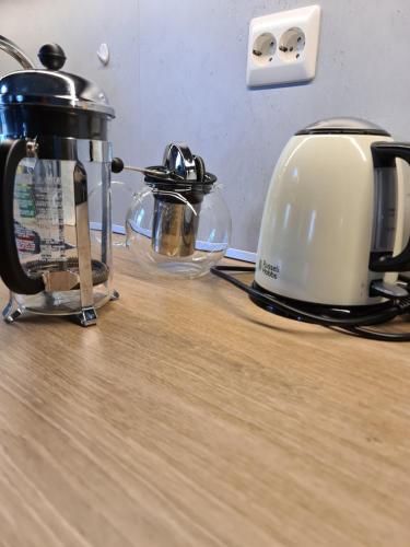 a toaster and tea kettle sitting on a wooden counter at Aurora Dream in Svensby