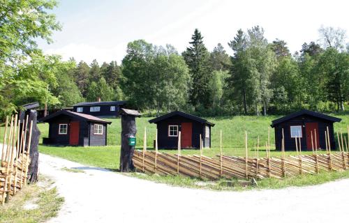 a wooden fence with a train on it at Ljoshaugen Camping in Dombås
