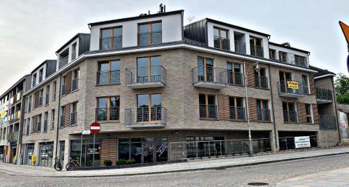 a large brick building on the corner of a street at ALEKSANDRA 2 - CONCRETE in Kielce