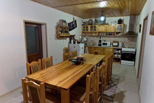 una cucina con tavolo in legno e sedie in legno di krushunska panorama a Krushuna