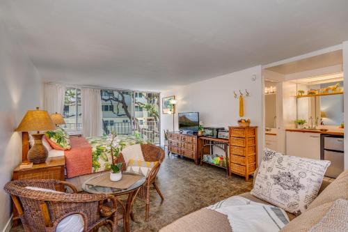 a living room with a couch and a table at @ Marbella Lane - Breezy Studio@Diamond Head Beach Hotel in Honolulu