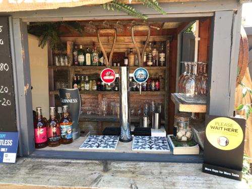 a store window of a store with bottles of alcohol at The Bridge House in Bridport