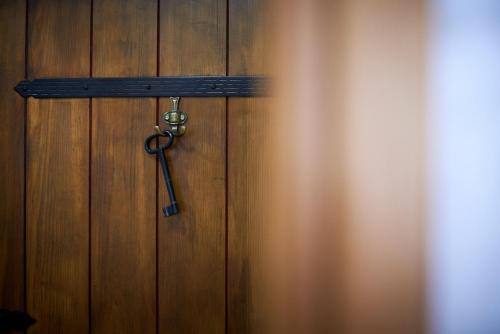 a pair of scissors hanging on a wooden door at Villa Kudelik - Stone Story in Trogir
