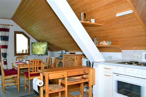 a kitchen and dining room with a staircase in a house at Ferienwohnung Wieserberg in Dellach