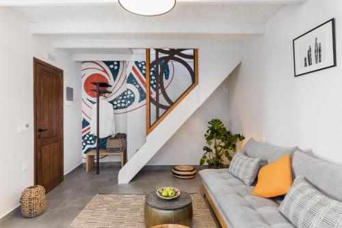 a living room with a couch and a staircase at Kamares Sanctuaries in Kolymvari