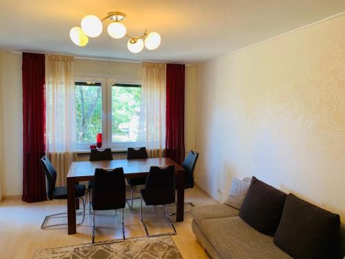 a living room with a table and a couch at MILA-Appartement in Karlsruhe