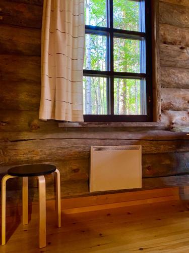 a room with a window and a chair and a radiator at Arctic Lodges Lapland Ski in Studio, slopes, ski tracks, National Park, free Wi-Fi - Lapland Villas in Pyhätunturi