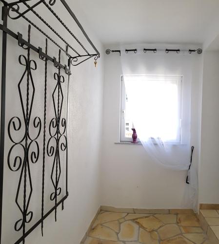 a room with a white wall and a window at Ferienhaus Alexandra in Böllenborn