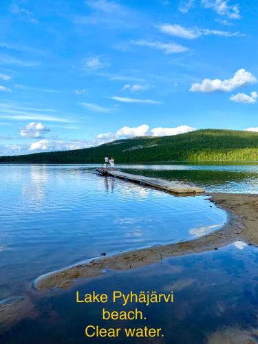 a group of people standing on a dock in the water at Arctic Lodges Lapland Ski in Studio, slopes, ski tracks, National Park, free Wi-Fi - Lapland Villas in Pyhätunturi