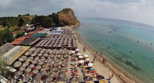 a group of umbrellas on a beach with the ocean at Popi' s apartment 50 metres from the sea! in Sozopoli