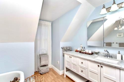 a bathroom with a sink and a mirror at Redwood Bed and Breakfast in Niagara Falls