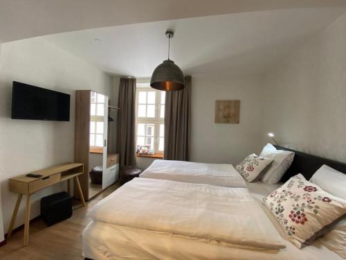 a bedroom with a large bed and a desk at Hotel Crasborn Thorn in Thorn