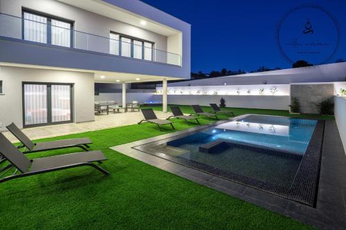 a house with a swimming pool in the yard at V5 Villa Emma - Luxury 5 bedroom villa in Alvor with private Pool and Jacuzzi in Alvor