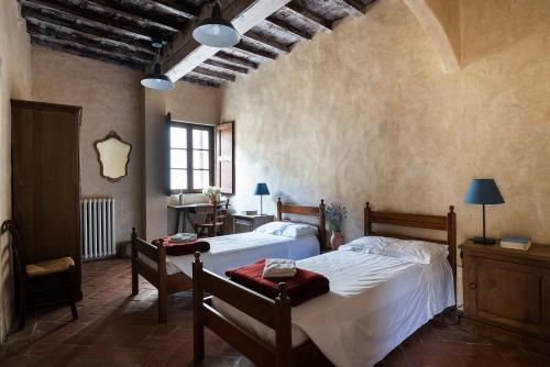 a bedroom with two beds in a room at Ostello del Bigallo in Bagno a Ripoli