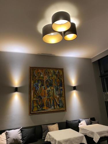a living room with a couch and a painting on the wall at Das Nikolai Hotel in Munich