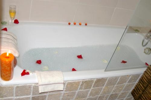 a candle sitting in a bath tub with a candle at Chez Petit in Argançon