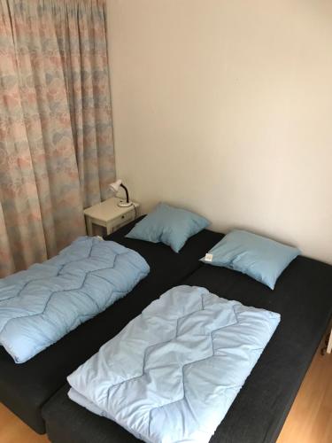 two beds sitting next to each other in a room at Holiday home Als in Augustenborg