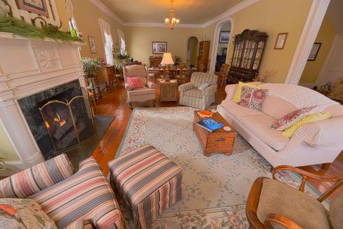 The Bed and Breakfast at Oliver Phelps في كاناندياجو: غرفة معيشة مع أريكة ومدفأة