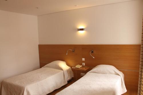 Un pat sau paturi într-o cameră la Hotel Zenite