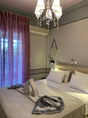 a bedroom with a bed with a blanket on it at Christopher's Apartments in Skala