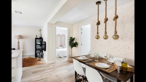 a dining room with a wooden table and white walls at Casa Yandiola in Castro-Urdiales
