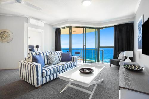 a living room with a couch and a table at Sun City Resort managed by Gchs in Gold Coast
