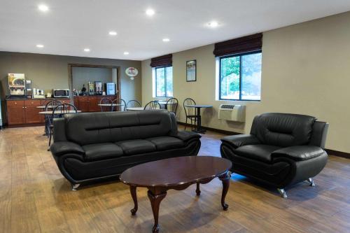 a living room with a couch and a table and chairs at Super 8 by Wyndham Cromwell/Middletown in Cromwell