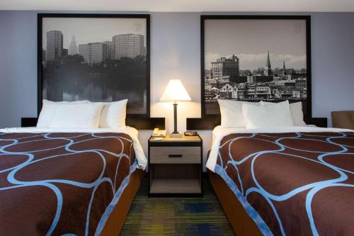 a hotel room with two beds and a city at Super 8 by Wyndham Cromwell/Middletown in Cromwell