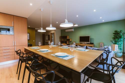 a large wooden table with chairs in a room at PRIME PARQUE RESIDENCE in São Martinho do Porto