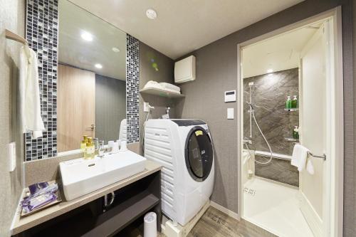 a bathroom with a sink and a shower at MONday Apart Hamamatsucho Daimon in Tokyo