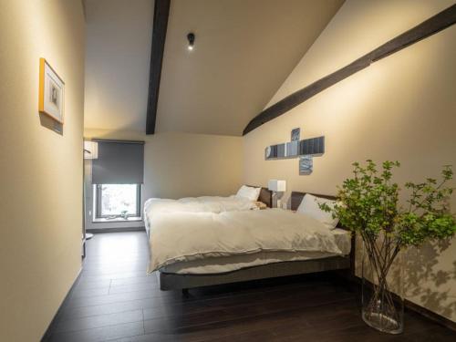 a bedroom with a large bed in a room at 4S STAY Awaikeda Honmachi Street in Miyoshi