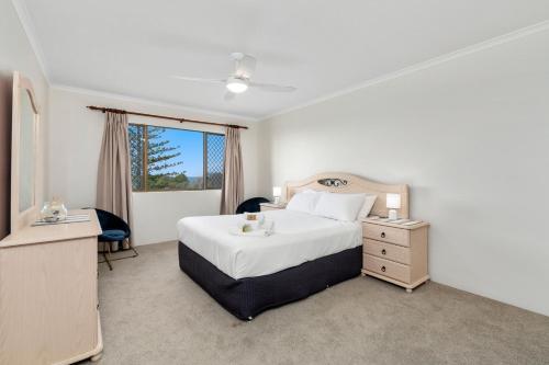 a hotel room with a bed and a window at Surfside Apartment 11 by Kingscliff Accommodation in Kingscliff