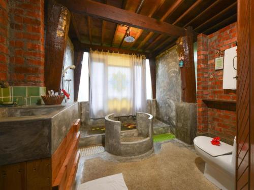 a bathroom with a sink and a toilet at MaliHom Private Estate in Balik Pulau