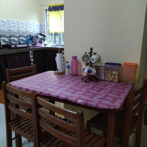 a table with a pink table cloth on it at Homestay Kak soh at KampungKalai, Jeli Kelantan in Jeli