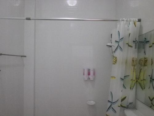 a bathroom with a shower with a shower curtain at The Theatre Villa in Bang Saphan