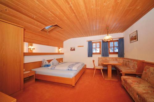 a bedroom with a bed and a wooden ceiling at Apart Lukas in Ischgl