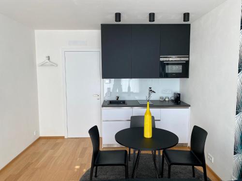 a kitchen with a table and chairs in a room at Business Apartments in Brno