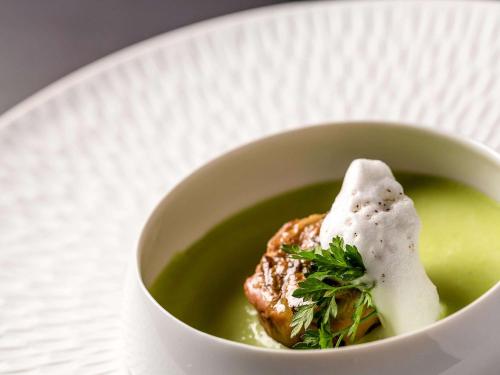 a bowl of soup with a piece of food in it at Mercure Compiègne Sud in Compiègne
