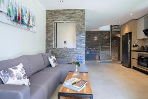 a living room with a couch and a table at KTENA RESIDENCE-Ktena Accomodation in Nydri