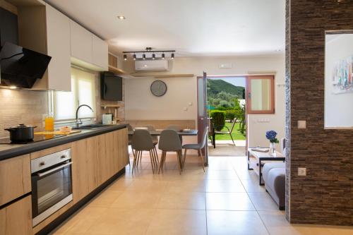 a kitchen and living room with a table and chairs at KTENA RESIDENCE-Ktena Accomodation in Nydri