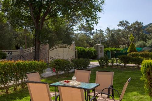 a table and chairs in a yard with a gate at KTENA RESIDENCE-Ktena Accomodation in Nydri