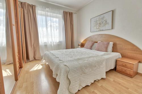 a bedroom with a large bed and a large window at Luxury Suites - Tatari by Rikas Hotels in Tallinn