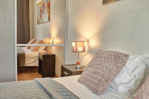 a hotel room with a bed and a mirror at Luxury Suites - Tatari by Rikas Hotels in Tallinn