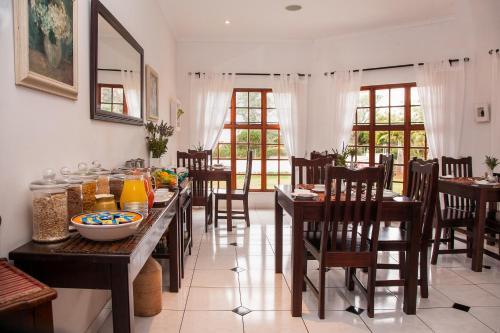 a dining room with wooden tables and chairs at Rivendell Bed and Breakfast in Hillcrest