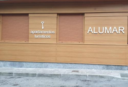 a pair of garage doors on a building at Alumar Apartamentos Muxia in Muxia