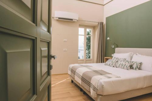 a bedroom with a bed and a window at Casa Rampolina in Stresa