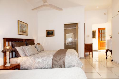 a bedroom with two beds and a ceiling fan at Rivendell Bed and Breakfast in Hillcrest