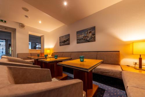 a waiting room with couches and tables at Trip Inn Hotel Esplanade, Düsseldorf in Düsseldorf