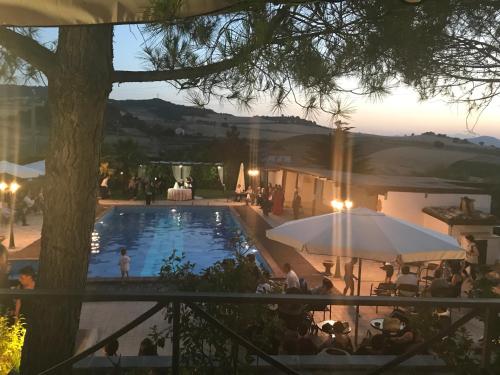 a view of a pool with people sitting around it at Al Settimo Cielo in Montenero di Bisaccia