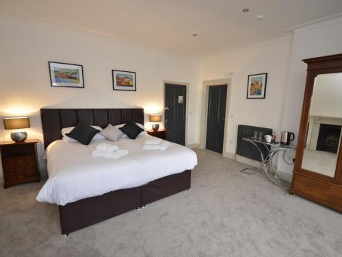 a bedroom with a large bed with towels on it at The Chapel House in Scarborough